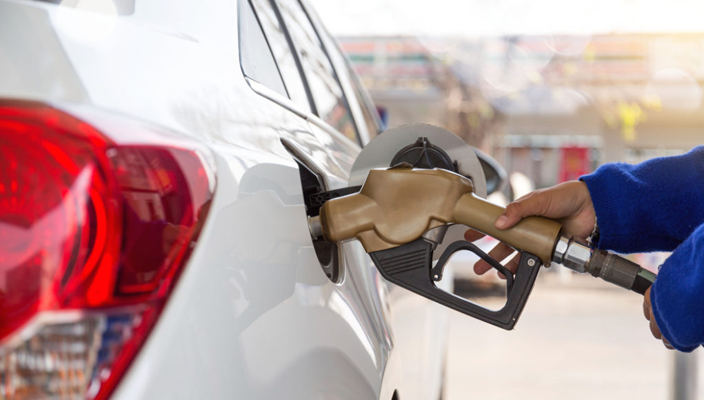 Pumping,Gasoline,Fuel,In,Car,At,Gas,Station.concept,Travel,And