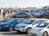 Marché voiture occasion 2026 : analyse d’une mutation du parc Parc automobile rempli de voitures d'occasion, incluant des modèles thermiques et électriques, avec des acheteurs au loin.